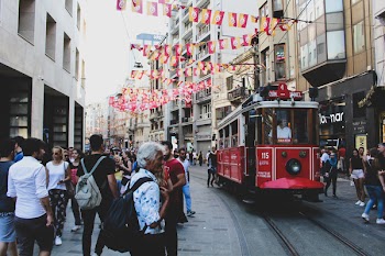 Pram Train Passing Through Building and People