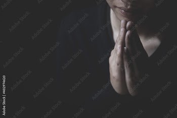  Praying hands with faith in religion and belief in God on dark background. Pay respect.  Namaste or Namaskar hands gesture.