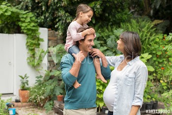 Pregnant family in garden