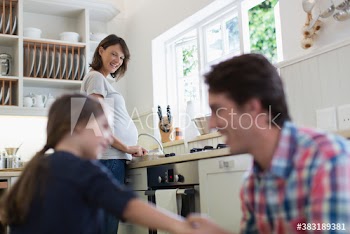 Pregnant family in kitchen
