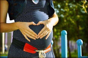 Pregnant Woman Holding Her Tummy during Daytime