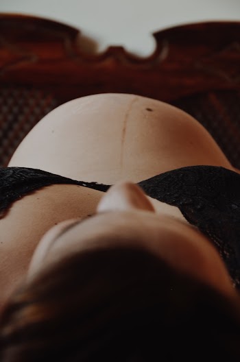 Pregnant Woman in Black Brassiere Lying on Her Back