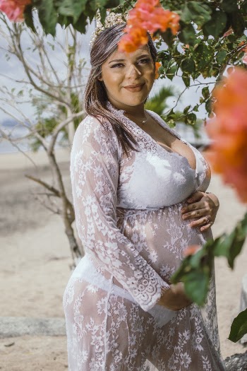 Pregnant Woman Wearing White Lace Sheer Dress at the Beach