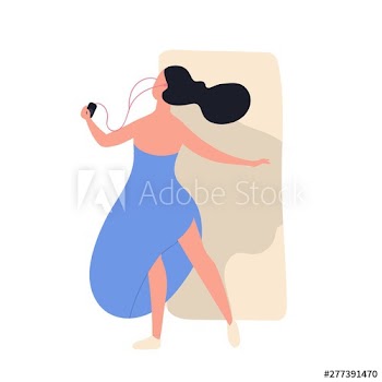 Pretty funny girl in dress listening to music and dancing