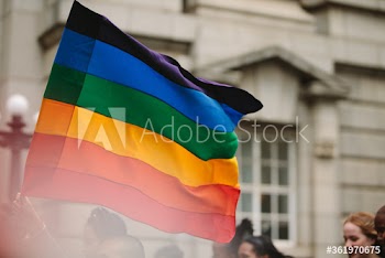 Pride parade with gay rainbow flag in the city