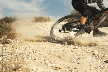 Professional bike rider during downhill ride on his bicycle