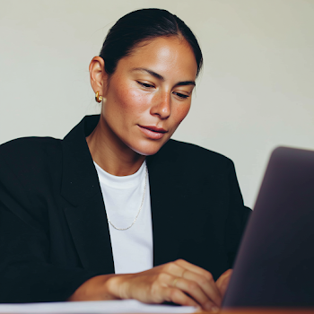 Professional Indian Woman Working on Laptop in Office Setting