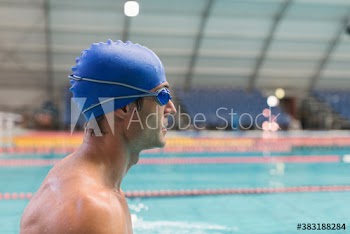 Profile male swimmer in swimming cap and goggles