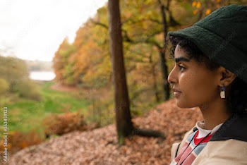 Profile view of young woman in forest