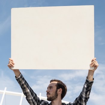 Protester holding board with mock-up for demonstration Free Photo
