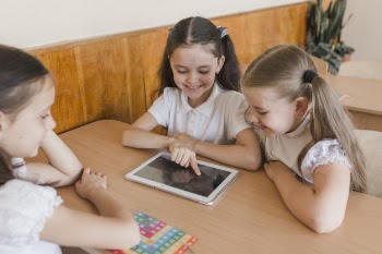 Pupils using tablet at classroom