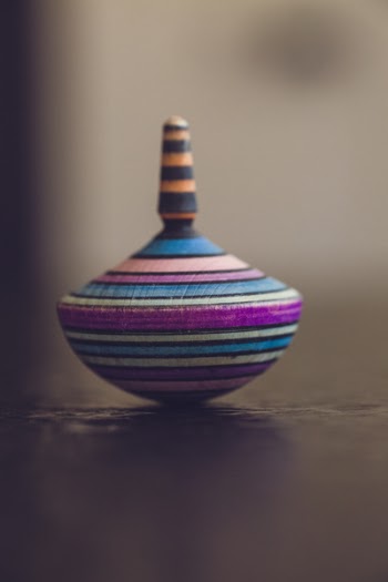Purple, Blue, and White Top Toy in Shallow Focus Photography