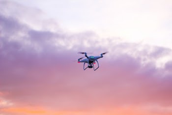Quadcopter Drone Flying Under Pink Sky