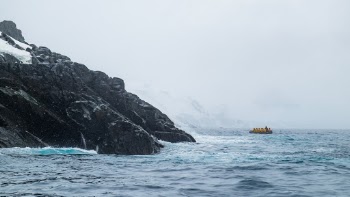 Quark Expeditions Zodiac excursion exploring the rocky shores of Spert Island (Antarctic Peninsula)
