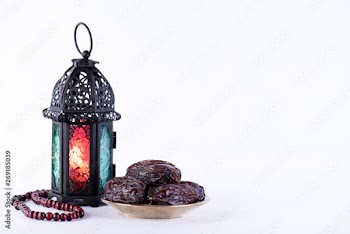 Ramadan food and drinks concept. Ramadan Lantern with arabian lamp, wood rosary, dates fruit and lighting on white background.