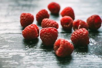 Raspberries on Black Wooden Board