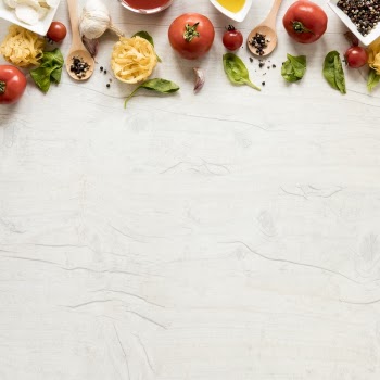 Raw pasta and it's ingredients arranged in row over white wooden table Free Photo