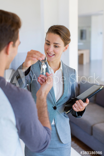 Realtor giving house keys to client