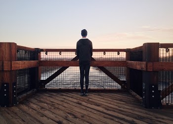 Rear View of a Man Walking on Beach