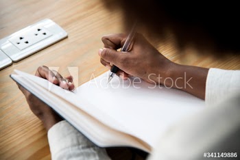 Rear view of woman writing a note