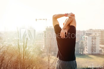 Rear view of young man exercising outdoors