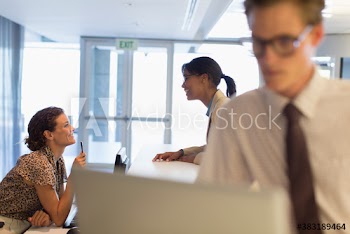 Receptionist talking with businesswoman