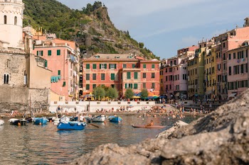 Red and Beige Painted Houses and Body of Water With Boats