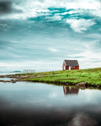 Red and Black Barn Near Body of Water