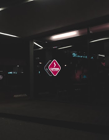 Red and Black Caffeine Text Signage