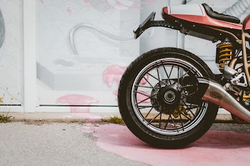 Red and Black Motorcycle Parked Near Wall