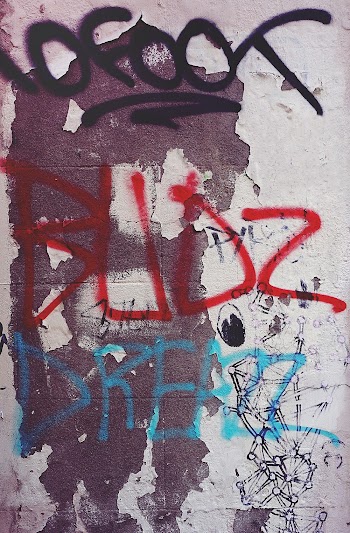 Red and Blue Text on White Painted Wall