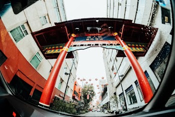 Red and Blue Traditional Archway Between White Buildings