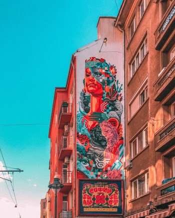Red and Blue Woman Painted Building Wall