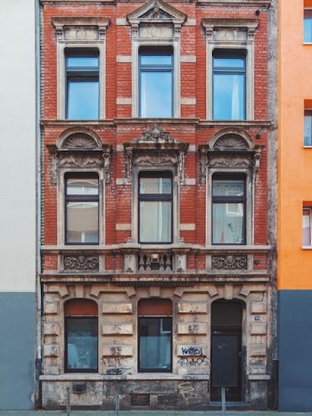 red and brown 3-storey house during daytime