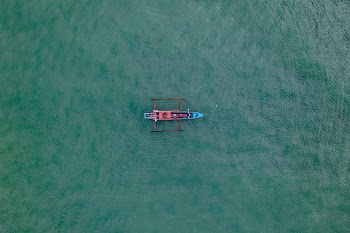 Red and Brown Canoe on Body of Water