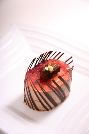 Red and Brown Oval Shape Chocolate Pastry on Ceramic Plate