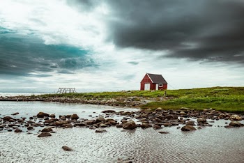 Red and Gray Barn Near Body of Water