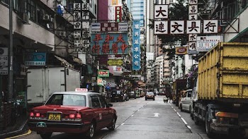 red and gray taxi on gray road