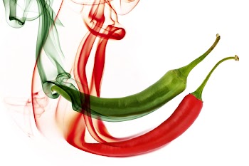 red and green hot chili pepper with color smoke on white
