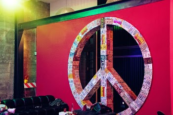 Red and Multicolored License Plate Covered Peace Sign Wall Decor