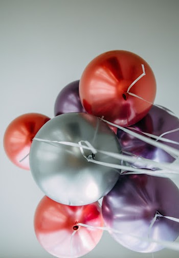 Red and Silver Balloons on White Surface