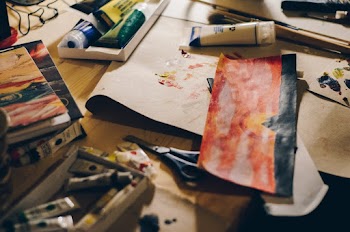 Red and White Abstract Painting on Brown Surface
