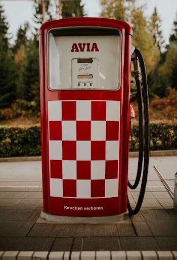red and white Avia gasoline machine