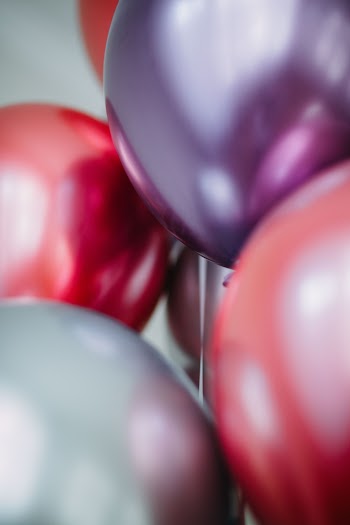 Red and White Balloons on White Wall