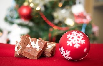 red and white bauble beside chocolates