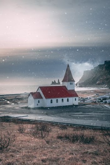 red and white church near brown mountain
