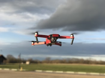 Red and White Drone Flying