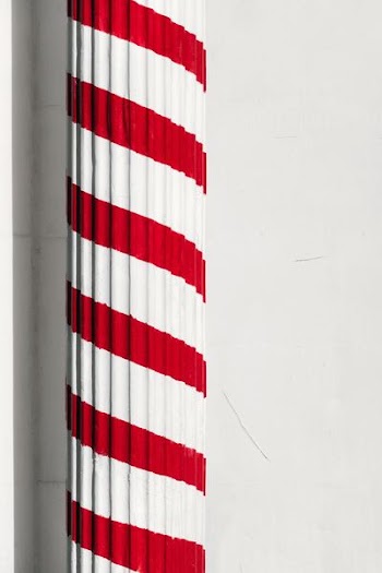 red and white painted pedestal column