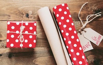 red and white polka-dot gift box beside gift wrappers