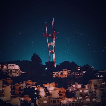 red and white signal tower at night